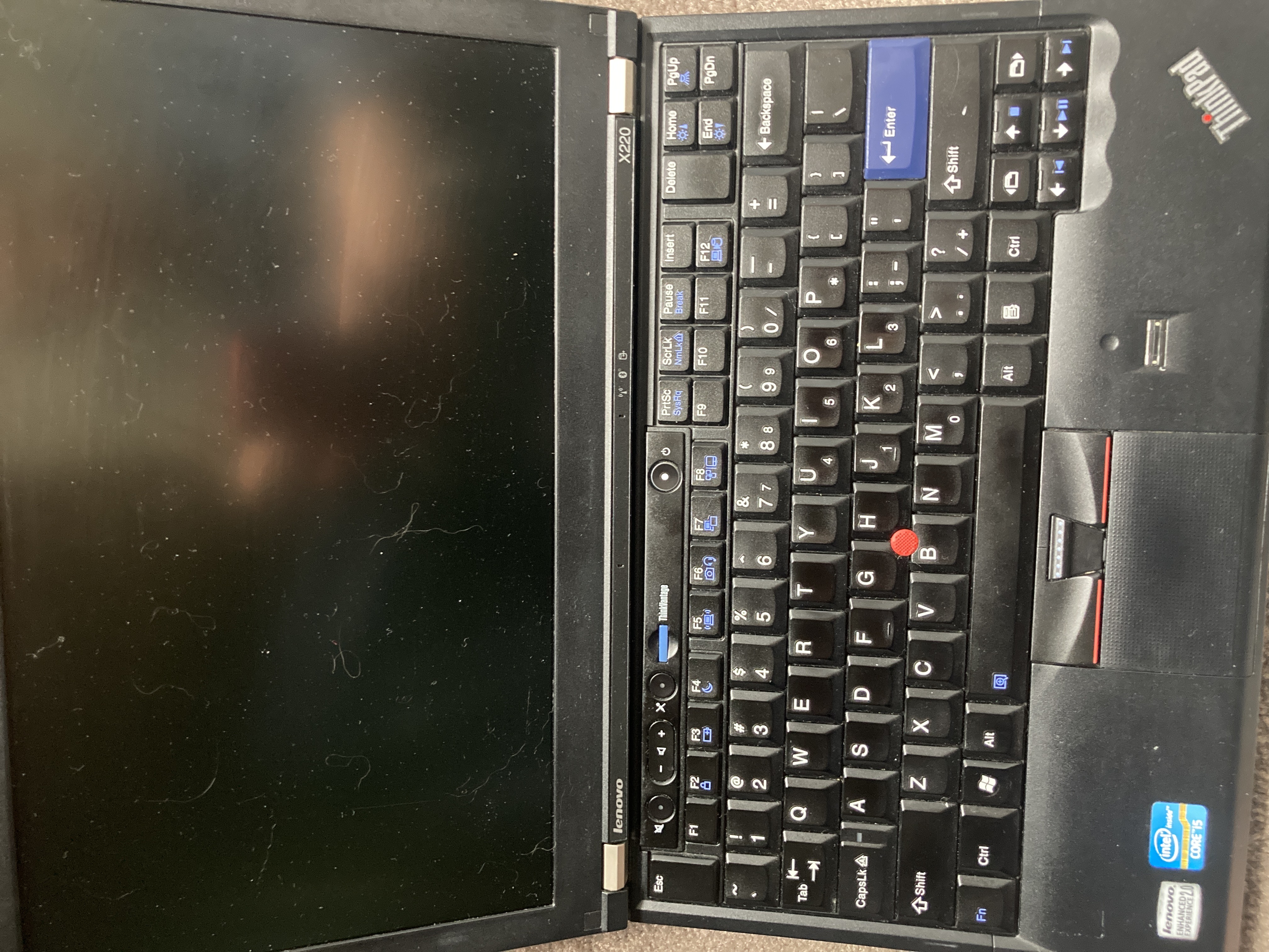 The thinkpad x220 with the lid
open, showing the screen and keyboard