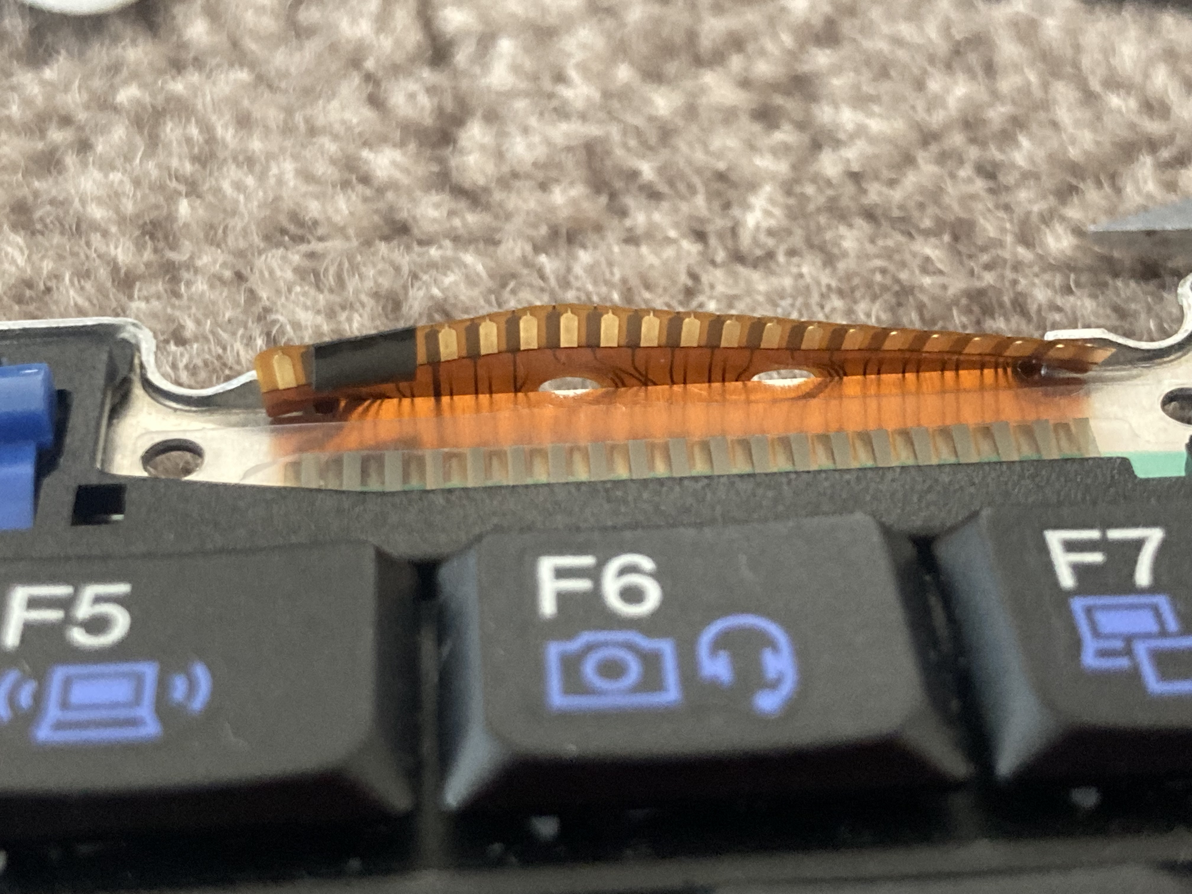 The keyboard ribbon cable with
electrical tape covering some of the contact pads