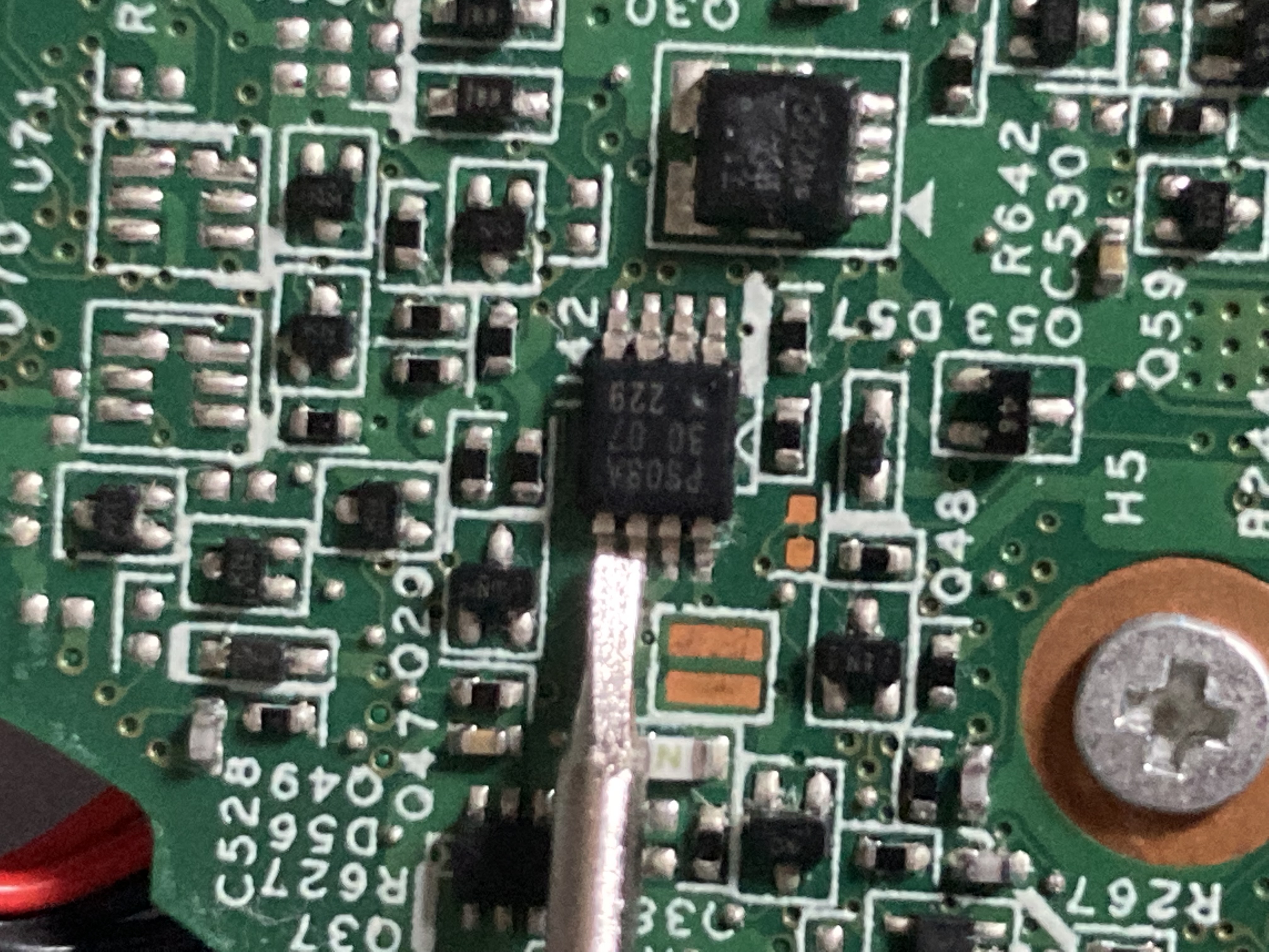 A small flat head screw driver
shorting the data and clock pins of the security EEPROM