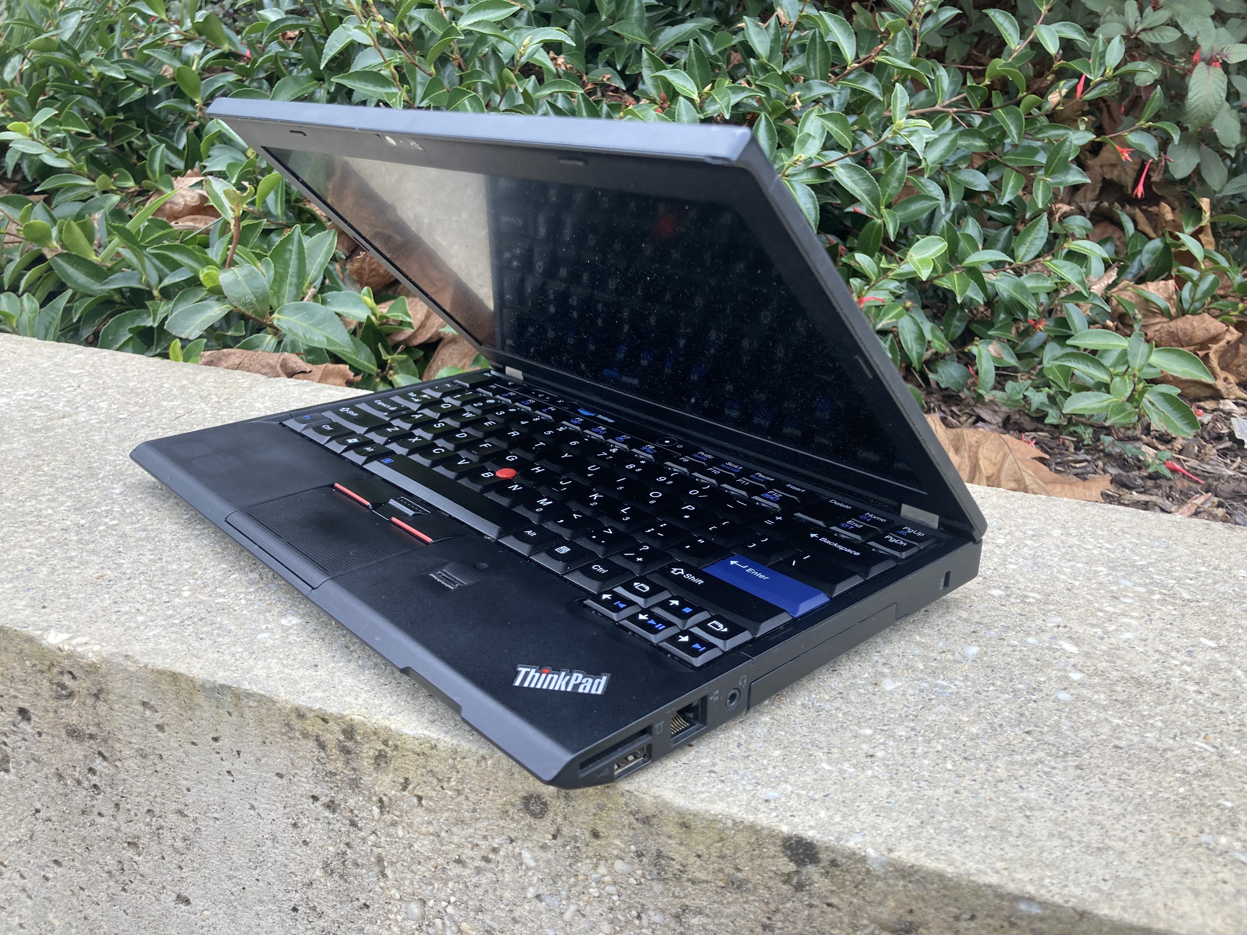 The thinkpad x220 with the lid
open, showing the screen and keyboard